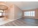 Open-concept living room with tile entry, gray floors and shuttered windows at 12204 Coldstream Ln, Tampa, FL 33626