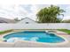 Backyard pool and spa surrounded by brick pavers and a white fence at 12204 Coldstream Ln, Tampa, FL 33626