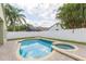 Backyard pool and spa surrounded by brick-paved patio and white vinyl fence for privacy at 12204 Coldstream Ln, Tampa, FL 33626