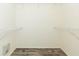 Bright walk-in closet featuring white wire shelving and wood-look flooring at 12204 Coldstream Ln, Tampa, FL 33626