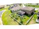 Aerial view of the property showcasing the screened pool and manicured lawn at 13111 Bahia Grass Ln, Riverview, FL 33579