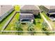 Aerial view of backyard featuring a screened-in pool, well-kept lawn, and a classic white picket fence at 13111 Bahia Grass Ln, Riverview, FL 33579