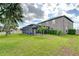 Expansive backyard featuring a screened-in pool and lush landscaping at 13111 Bahia Grass Ln, Riverview, FL 33579