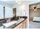 Bathroom vanity featuring double sinks, granite counters, and wood cabinets at 13111 Bahia Grass Ln, Riverview, FL 33579