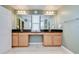 Well-lit bathroom with double sinks, large mirrors, and a clean design at 13111 Bahia Grass Ln, Riverview, FL 33579