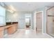 Serene bathroom featuring double sinks, granite counters, and walk-in shower at 13111 Bahia Grass Ln, Riverview, FL 33579