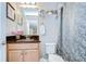 Well-lit bathroom features vanity, a framed mirror, and a shower/tub combo at 13111 Bahia Grass Ln, Riverview, FL 33579