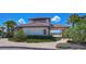 Elegant community building surrounded by vibrant landscaping and palm trees at 13111 Bahia Grass Ln, Riverview, FL 33579