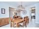 Traditional dining room with wood table, cabinet, and decorative light fixture at 13111 Bahia Grass Ln, Riverview, FL 33579