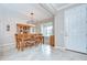 Inviting dining room with tile flooring, a modern chandelier, and ample natural light at 13111 Bahia Grass Ln, Riverview, FL 33579