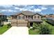 Charming two-story home with a well-maintained lawn and attached two-car garage at 13111 Bahia Grass Ln, Riverview, FL 33579