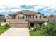 Charming two-story home featuring a three-car garage, well-maintained landscaping, and a welcoming front porch at 13111 Bahia Grass Ln, Riverview, FL 33579