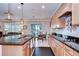 Open kitchen flowing into the living area with granite counters and stainless steel appliances at 13111 Bahia Grass Ln, Riverview, FL 33579