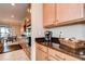 Well-lit kitchen featuring granite countertops and wooden cabinetry at 13111 Bahia Grass Ln, Riverview, FL 33579
