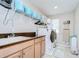 Functional laundry area featuring a sink, washer, dryer and plenty of storage space at 13111 Bahia Grass Ln, Riverview, FL 33579
