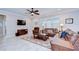 Comfortable living room featuring plush seating, a large rug, and a ceiling fan at 13111 Bahia Grass Ln, Riverview, FL 33579