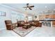 Inviting living room with leather sofas and abundant natural light at 13111 Bahia Grass Ln, Riverview, FL 33579