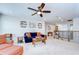 Carpeted upstairs living room with comfortable seating, fan and natural light at 13111 Bahia Grass Ln, Riverview, FL 33579