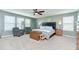 Light-filled main bedroom with carpet, fan, and ample windows at 13111 Bahia Grass Ln, Riverview, FL 33579