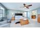 Bright main bedroom with carpet, fan, and comfortable seating area at 13111 Bahia Grass Ln, Riverview, FL 33579