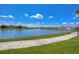 Scenic view of a community pond with a fountain and sidewalk perfect for enjoying the outdoors at 13111 Bahia Grass Ln, Riverview, FL 33579