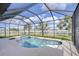 Sparkling pool and spa enclosed in a screened-in lanai for year-round enjoyment at 13111 Bahia Grass Ln, Riverview, FL 33579