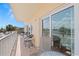 A sunny balcony with comfortable seating and sliding glass doors offers views of the surrounding area at 13440 Gulf Blvd # 202, Madeira Beach, FL 33708