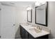 A bright bathroom boasts double sinks and ample lighting at 13440 Gulf Blvd # 202, Madeira Beach, FL 33708