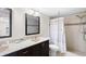 Well lit bathroom features double sinks, shower, and decorative accents at 13440 Gulf Blvd # 202, Madeira Beach, FL 33708