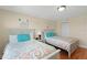 Bright bedroom featuring two cozy beds and wood flooring at 13440 Gulf Blvd # 202, Madeira Beach, FL 33708
