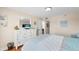 Bedroom featuring bed, dresser with TV, and ensuite bathroom access at 13440 Gulf Blvd # 202, Madeira Beach, FL 33708