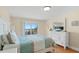 Bright bedroom featuring a comfortable bed and a sunny balcony view at 13440 Gulf Blvd # 202, Madeira Beach, FL 33708