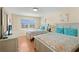 Comfortable bedroom with two beds, beach decor and natural light at 13440 Gulf Blvd # 202, Madeira Beach, FL 33708
