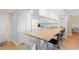 Kitchen with bar seating, white cabinets, and standard appliances at 13440 Gulf Blvd # 202, Madeira Beach, FL 33708