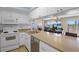 The kitchen features white appliances and ample counter space at 13440 Gulf Blvd # 202, Madeira Beach, FL 33708