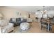 Cozy living area with blue accents, kitchen view, and tile flooring at 13440 Gulf Blvd # 202, Madeira Beach, FL 33708