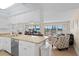 Open-concept living space with kitchen, dining, and living areas at 13440 Gulf Blvd # 202, Madeira Beach, FL 33708