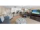 Combined kitchen and living area with dining table and TV at 13440 Gulf Blvd # 202, Madeira Beach, FL 33708