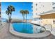 Enjoy this pristine pool perfect for relaxation with lounging chairs and access to beach at 13440 Gulf Blvd # 202, Madeira Beach, FL 33708