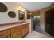 Elegant bathroom featuring a walk-in shower with glass door, updated vanity, and granite countertop at 14175 Feather Sound Dr, Clearwater, FL 33762