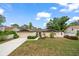 Charming single-story home with a well-manicured lawn and mature landscaping, complete with a two-car garage at 14175 Feather Sound Dr, Clearwater, FL 33762