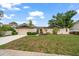 Charming single-story home with neutral paint, two-car garage and landscaped front yard at 14175 Feather Sound Dr, Clearwater, FL 33762