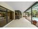 Covered patio area with built-in bar overlooking the pool and outdoor living space at 14175 Feather Sound Dr, Clearwater, FL 33762