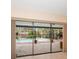 View of the enclosed pool from a patio, showcasing the outdoor space and lush landscaping at 14175 Feather Sound Dr, Clearwater, FL 33762