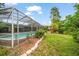 Screened-in pool with lush backyard, ideal for relaxation and outdoor enjoyment at 14175 Feather Sound Dr, Clearwater, FL 33762