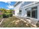 Outdoor patio with sliding glass door and lush landscaping at 15604 Deerglen Dr, Tampa, FL 33624