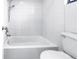 Clean and modern bathroom featuring a white tiled shower and tub combination and toilet at 15604 Deerglen Dr, Tampa, FL 33624