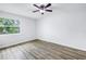 Bright bedroom with wood floors and a window overlooking lush greenery at 15604 Deerglen Dr, Tampa, FL 33624