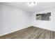 A spacious bedroom with light colored, wood look flooring and bright natural light at 15604 Deerglen Dr, Tampa, FL 33624