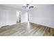 Bedroom with hardwood flooring and view of the laundry room at 15604 Deerglen Dr, Tampa, FL 33624